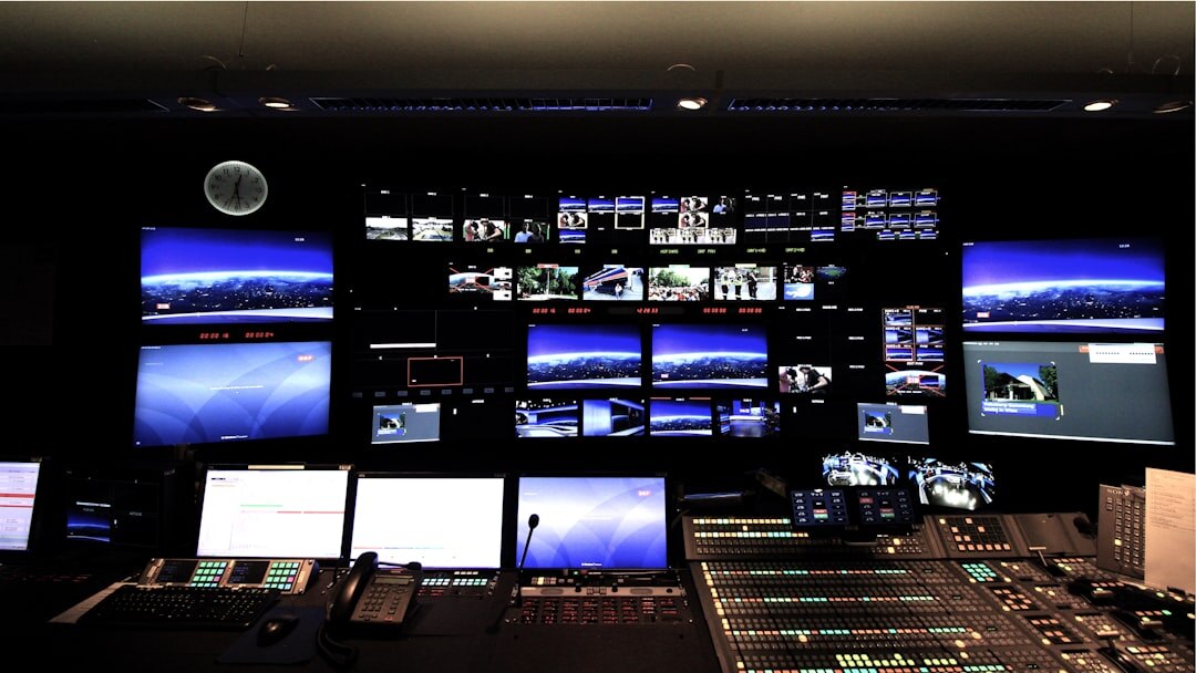 Television broadcast control room with multiple screens